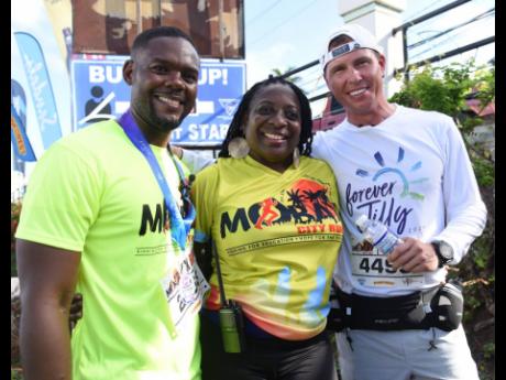 Janet Silvera (centre), chairperson of the Jill Stewart Mobay City Run is flanked by Mayor of Montego Bay Richard Vernon (left) and Adam Stewart, executive chairman of Sandals Resorts International.