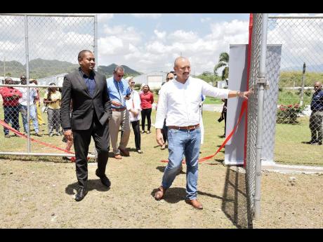 Ian Allen
Matthew Lyn (right), CEO, CB Group, escorts Floyd Green (left), minister of agriculture and fisheries, into the state-of-the-art solar photovoltaic power plant at the Peninsula Farm in Banbury, Linstead, St Catherine, yesterday.