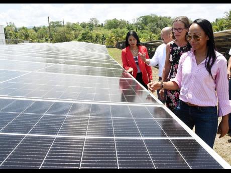 Angella Rainford (right), CEO, Soleco Energy, shows off the solar panels recently installed at the Peninsula Farm to Georgette Smith (left), COO, Private Sector Organisation of Jamaica; Matthew Lyn (second left), CEO, CB Group; and Judith Slater, British h