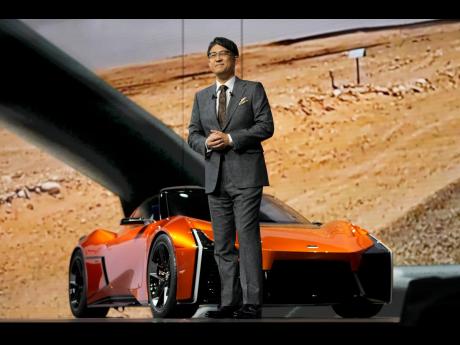 AP 
Toyota Motor Corp CEO Koji Sato, standing in front of the sporty FT-Se, at the Japan Mobility Show in Tokyo, October 25, 2023.