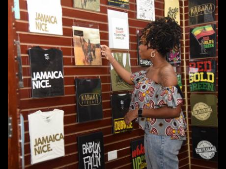 Rashida Grant, marketing coordinator, Supreme Audio and Electronics, views the merchandise on display at Street Supply Co. 