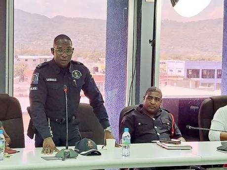 Senior Superintendent of Police Eron Samuels (left), the commanding officer in charge of the St James Police Division, presents the Jamaica Constabulary Force’s monthly report to the St James Municipal Corporation during its monthly meeting on Thursday. 