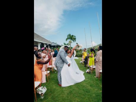 Surrounding by their nearest and dearest after their “I do’s”, the Charleses share one of many intimate moments on their special day.