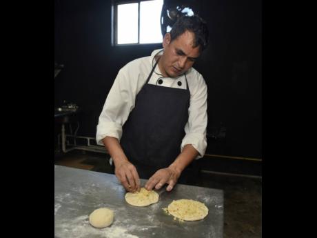 Chef Ramiesh Singh expertly prepares garlic naan which he will soon put to bake in the on-site tandoor.