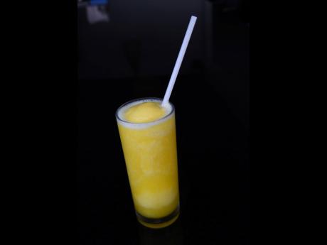 The mango lassi, a signature drink at Manzil, is a blended drink of creamy yoghurt and sweet mango.