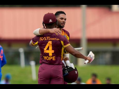 West Indies’ Brandon King and Shai Hope embrace after beating India by eight wickets in the fifth T20 cricket match at Central Broward Regional Park in Lauderhill, Forida, on August 13, 2023. 