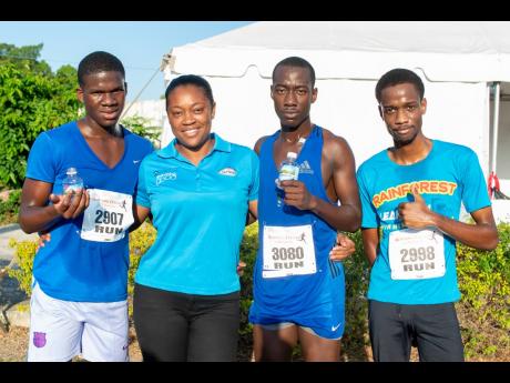 Catherine’s Peak brand representative Rochell Johnson (second left) with the top male finishers (from left) Jemar McTaggart, third-place runner; Sanjay Irvine, first-place runner; and Phillip Bushay, second-place runner, at the Jamaica Police Co-operativ