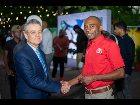 Grace Foods Limited Managing Director Dave DaCosta (right) greets Olivier Guyonvarch, ambassador of France to Jamaica, during the Jamaica Olympic Association launch event on May 16.