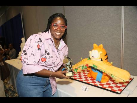 It was only fitting that for the eighth staging of the event, cake number eight, Garfield the cat, won the People’s Choice Award in the pre-decorated cake competition. Master baker and cake designer Rochelle Makyn poses proudly beside her stunning creati