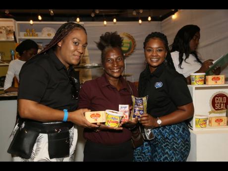 Taking the spotlight is Carleen Doiler (centre), who collected her prize from Camille Moore (left), brand manager for Chiffon and Gold Seal Margarine, and Daynah Parchment, brand manager for Eve.
