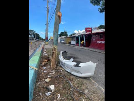 The bumper of the car that was being driven by Job Nelson lies beside a broken utility pole, bearing witness to the tragedy that unfolded on Tuesday night.