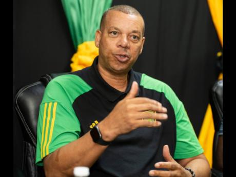 Reggae Girlz head coach Hubert Busby Jr speaks during a Jamaica Football Federation press conference at its headquarters in St Andrew yesterday.