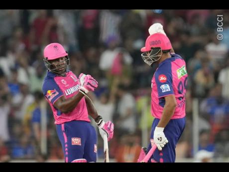 West Indies World Cup captain Rovman Powell (left) gestures to Ravichandran Ashwin after hitting the winning runs for Rajasthan Royals against Royal Challengers Bangalore in the elimination final of the IPL yesterday in Ahmedabad.