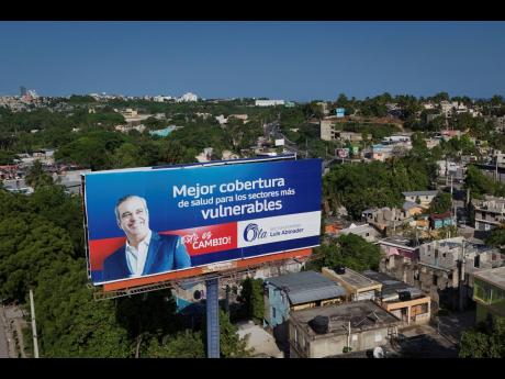A political billboard promotes the candidacy of incumbent President Luis Abinader, who has won a second term.