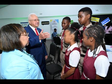 Justice Minister Delroy Chuck (second left) and Grace-Ann Stewart McFarlane (left), permanent secretary at the Ministry of Justice, chat with Kellits High School students (from third left) Deon-Tay Kelly, Josiah Pinnock, Nhajami Smith and Trishanna Rose at