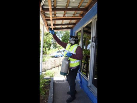 Allen Webster, of the Rural Agricultural Development Agency, conducts a pest-control exercise during Labour Day activities at the Summit Police Station in Montego Bay, St James, on Thursday.