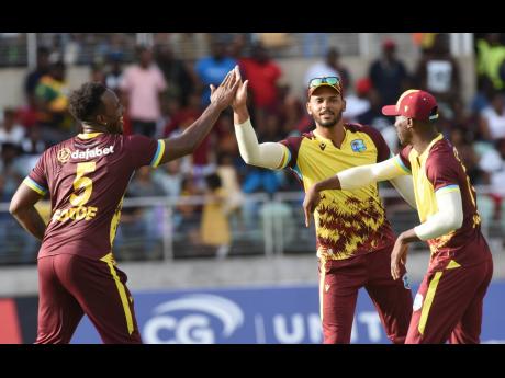 West Indies captain Brandon King (centre) celebrates a South African wicket with Matthew Forde (left) and Shamar Joseph during their opening T20 at Sabina Park yesterday. 