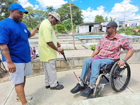 From left: Dwight Crawford, deputy mayor of Montego Bay and the St James Municipal Corporation’s councillor for the Spring Gardens division, interacts with Robert Blake, president of the Jamaica Society for the Blind’s Montego Bay chapter, and Andrew E
