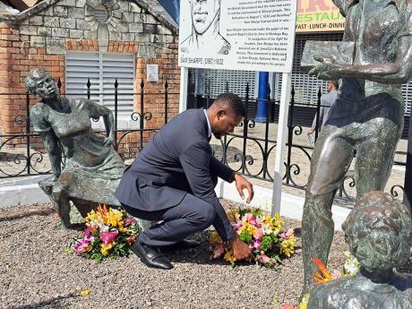 Montego Bay Mayor Richard Vernon lays a wreath among the memorial statues of National Hero Samuel Sharpe and his fellow slaves in Sam Sharpe Square, Montego Bay, St James, ahead of participating in Labour Day activities on Thursday, May 23, 2024.