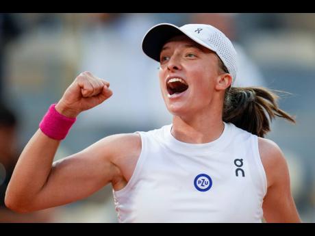 Poland’s Iga Swiatek celebrates winning her semifinal match at  last year’s French Open tennis tournament against Brazil’s Beatriz Haddad Maia in two sets, 6-2, 7-6 (9-7), at Roland Garros stadium in Paris.