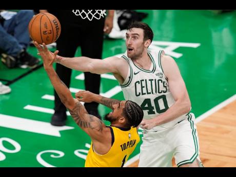 Indiana Pacers forward Obi Toppin (1) puts up a shot against Boston Celtics (centre) Luke Kornet (40) during the third quarter of Game 1 of the NBA Eastern Conference basketball finals on Tuesday in Boston.
