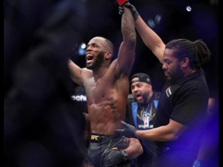 Leon Edwards (left) celebrates his victory over Kamaru Usman in the welterweight title bout at the UFC 286 mixed martial arts event Saturday, March 18, 2023, in London. 