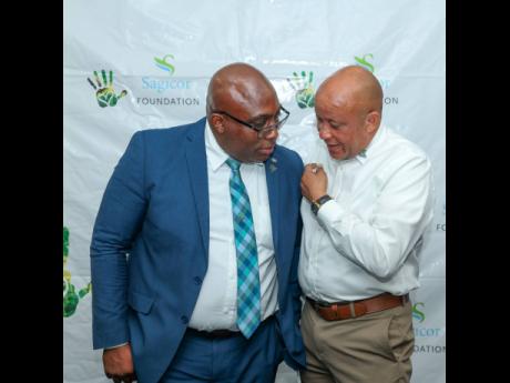 President of the Jamaica Teachers Association (JTA) Leighton Johnson (left) and Chief Revenue Officer of Insurance, Sagicor Life Jamaica and Director at Sagicor Foundation Mark Chisholm caught deep in conversation at the JTA/Sagicor National Primary School