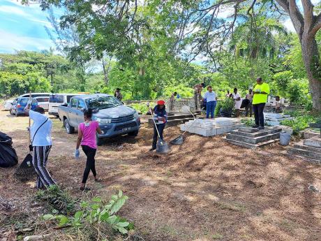Volunteers engage in a cleaning-up and beautification exercise at the Pye River Cemetery in Bogue, Montego Bay, St James, for the parish’s Labour Day 2024 project on Thursday.