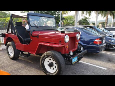 A red Willy Jeep stands ready to conquer any terrain.  