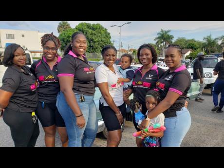 She Likes Cars Too! Ladies show their automotive enthusiasm at the event. (From left to right) Celine Mitchell, Lori-ann Bramwell, Rochelle Christie, SamiJoe, Samantha Roberts and Sheneyl Ruddock.