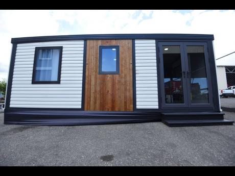 With a steel container as the frame, this unit boasts two bedrooms, a bathroom, living, dining, and kitchenette.
