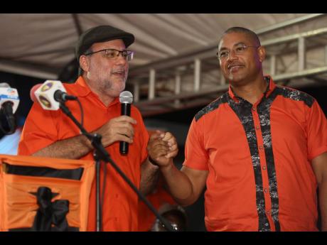 Opposition Leader Mark Golding with Mikael Phillips, member of parliament for Manchester North Western.