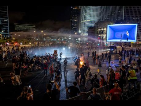 Police use water cannon to disperse demonstrators in Tel Aviv during a protest against Israeli Prime Minister Benjamin Netanyahu’s government, and calling for the release of hostages held in the Gaza Strip by the Hamas militant group.