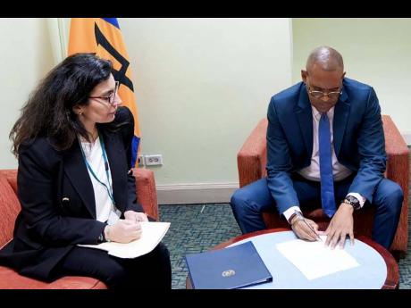 Minister of Foreign Affairs and Foreign Trade, Kerrie Symmonds, signs the joint declaration to address supply chain issues affecting SIDS in the presence of Chief, Transport Section of Trade Logistics Branch, Division on Technology and Logistics, UNCTAD, F