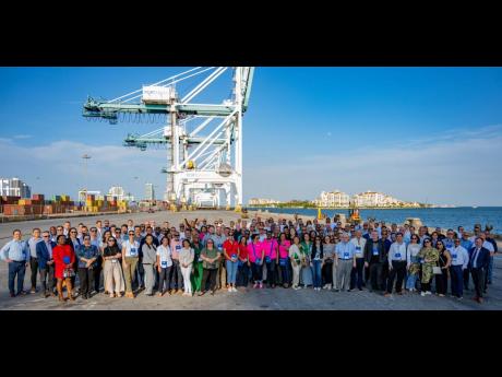 Delegates of the Caribbean Shipping Executives’ Conference share a photo op on the container terminal of PortMiami.