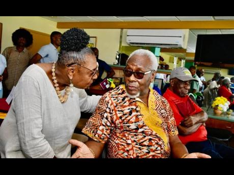 Sports Minister Olivia Grange (left) greeting former Prime Minister P.J. Patterson at a cricket match between the West Indies and South Africa at Sabina Park in Kingston on the weekend.