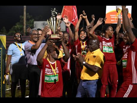 KSAFA president, Mark Bennett (centre), celebrates along with Boys’ Town, winners of the KSAFA Championship on Sunday night at the Anthony Spaulding Sports Complex.