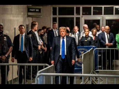 Former United States President Donald Trump (centre) walks out of a Manhattan court in New York on Thursday after being convicted on 34 felony counts in his hush-money case.