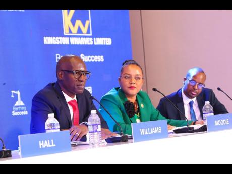 Kingston Wharves CEO Mark Williams (left) addresses shareholders at the company’s annual general meeting held at the AC Hotel. He is supported by Group Chief Financial Officer Clover Moodie and legal counsel Stephan Morrison.