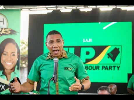 Prime Minister Andrew Holness addressing the St Andrew East Rural constituency conference on the weekend. Holness, who is the leader of the Jamaica Labour Party, urged party faithful to not be drawn in by rumours spread by political operatives.