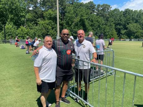 From left: Gerry Mouttet and Gary Peart, chairman Supreme Ventures Limited pose with head coach of the Reggae Rovers Marcelo Castillo in Cary North Carolina at the TST Soccer Tournament on Saturday.
