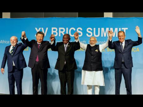 From left, Brazil’s President Luiz Inacio Lula da Silva, China’s President Xi Jinping, South Africa’s President Cyril Ramaphosa, India’s Prime Minister Narendra Modi, and Russia’s Foreign Minister Sergei Lavrov pose for a BRICS group photo during