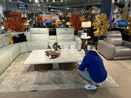 A shopper pauses at a display in a furniture store Sunday, June 2, 2024, in Englewood, Colorado.
