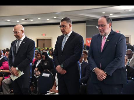 (From left) Governor General Sir Patrick Allen, Prime Minister Andrew Holness, and Leader of the Opposition Mark Golding pray at the National Leadership Prayer Breakfast held in January.