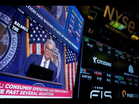 
A screen displays a news conference with US Federal Reserve Chairman Jerome Powell on the floor at the New York Stock Exchange in New York on May 1, 2024. Inflation cooled in May, but the Fed left its key interest rate unchanged on Wednesday, June 12, 202