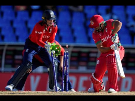 Oman’s Fayyaz Butt is clean bowled by England’s Adil Rashid during an ICC Men’s T20 World Cup cricket match at Sir Vivian Richards Stadium in North Sound, Antigua and Barbuda, yesterday.