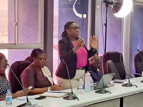 Dr Tanique Bailey-Small (standing), St James’ medical officer of health, addresses the monthly meeting of the St James Municipal Corporation on Thursday. Also pictured is Sherika Lewis, St James’ acting chief public health inspector.