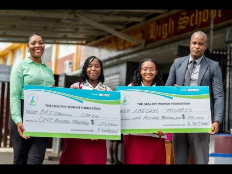 Nichelle Nembhard (left) and Principal of Spanish Town High, Damion Lawrence (right), shares a proud moment with Brizannie Craig (second left) and Abigail Morris, both recipients of the Future Leaders Scholarship. 