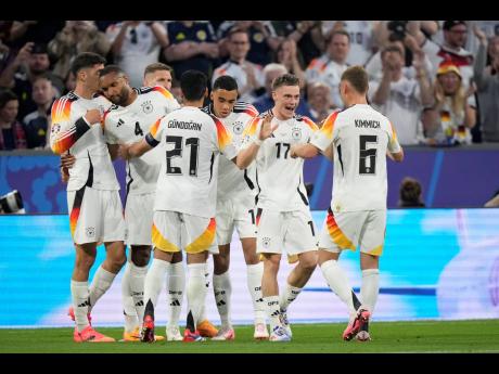 Germany’s Florian Wirtz (second right) celebrates with teammates after scoring his side’s opening goal during a Group A match between Germany and Scotland at the Euro 2024 soccer tournament in Munich, Germany yesterday. Germany won 5-1.
