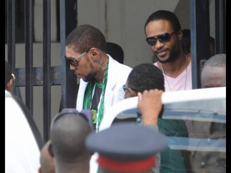 File photo shows entertainer Vybz Kartel (front) and Shawn Storm leaving the Home Circuit Court in Kingston.